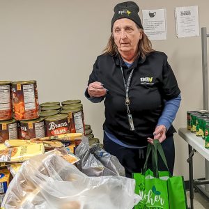 Woman standing by canned goods