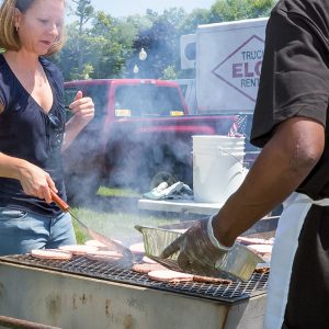 Two people grilling hamburgers