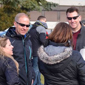 Small group of people talking at an outdoor event