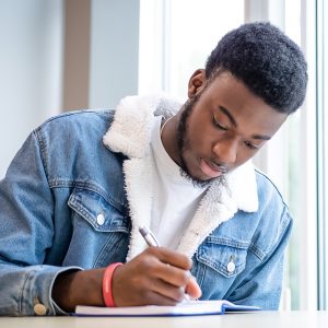 Man writes in notebook