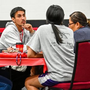 Three people sitting at table having a conversation