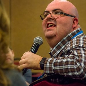 Man speaks into a microphone at an event