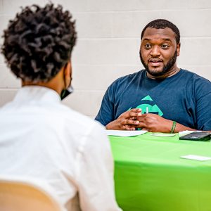 Two people sitting at a table talking