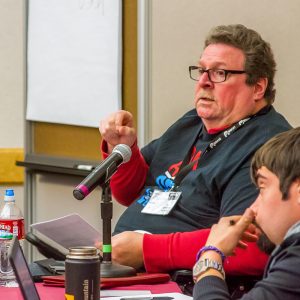 Man with a disability speaking into a microphone