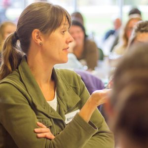 Woman asking a question at an event