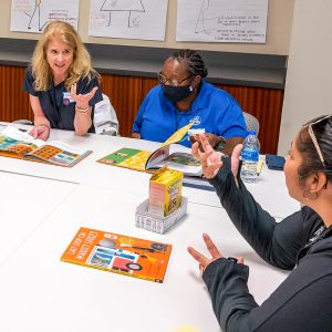 Three people talking at a table