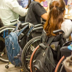 Several people in wheelchairs at a table