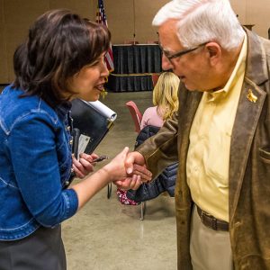 Woman shaking hands with an older man