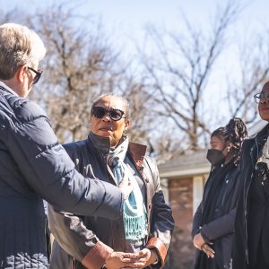 Four women standing outside talking