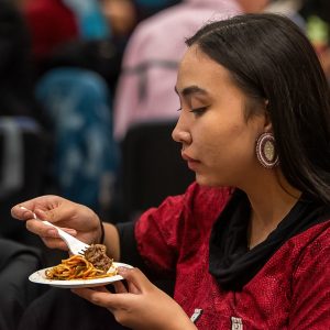 Woman eating food at an event